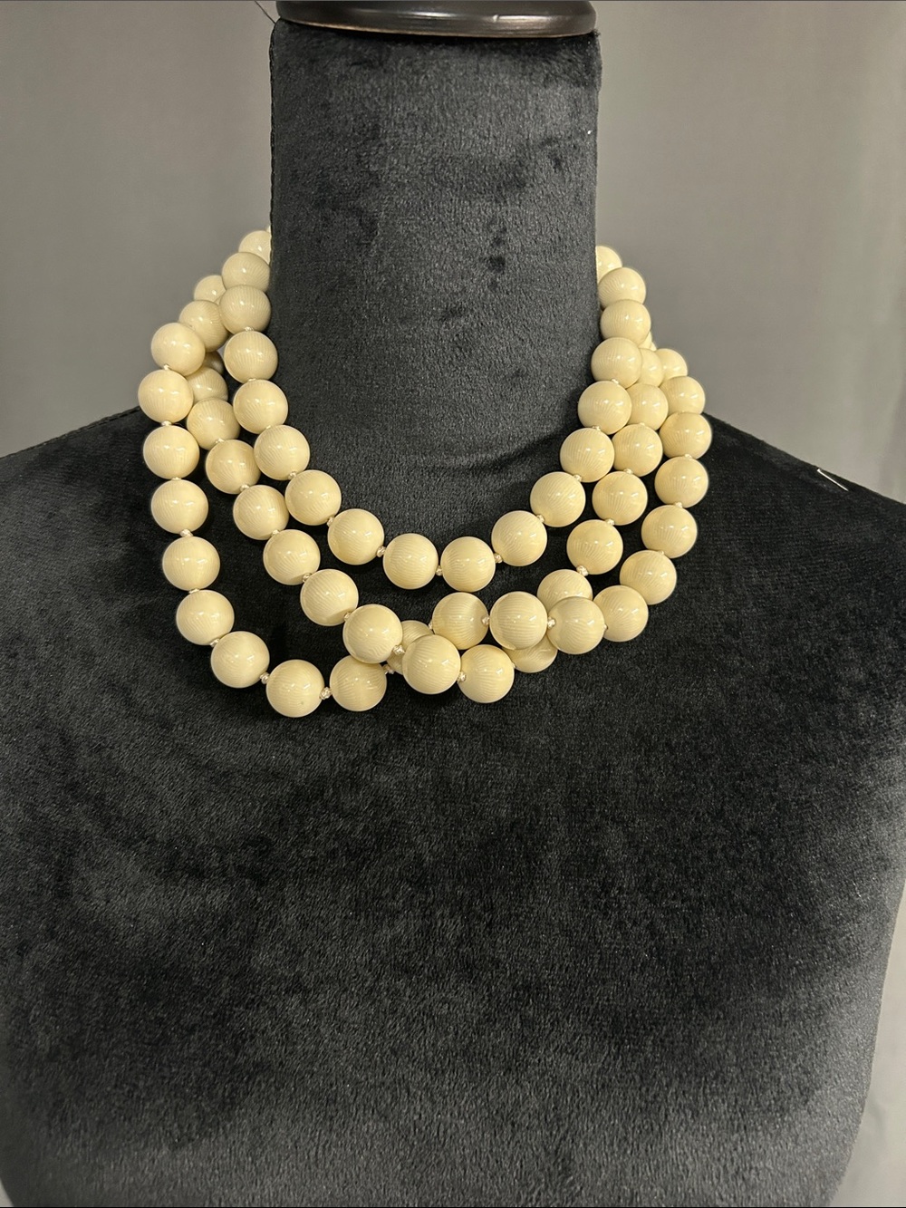 Chunky Les Bernard 
triple strand necklace with faux ivory beads